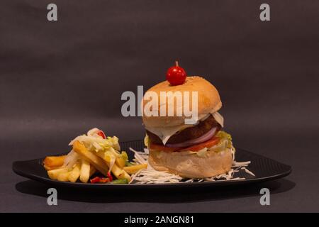 Burger and potato fries, table top close-up Stock Photo