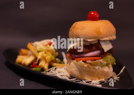 Crispy burger and potato fries, table top close-up Stock Photo