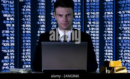 Rich businessman smiling on codes and numbers background, stock exchange profit Stock Photo