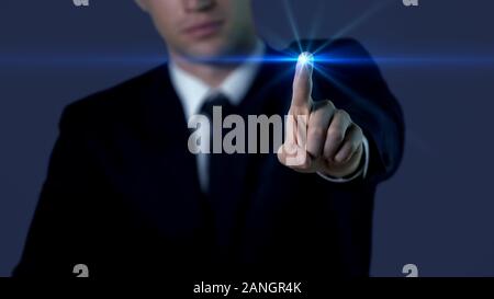 Man in suit touching screen, fingerprint access, modern technologies, future Stock Photo