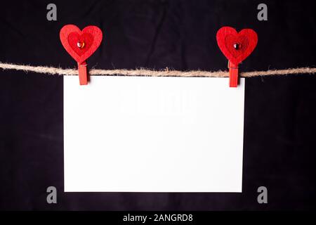Hanging blank card of black background. Stock Photo