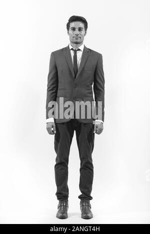 Full body shot of young handsome Persian businessman Stock Photo