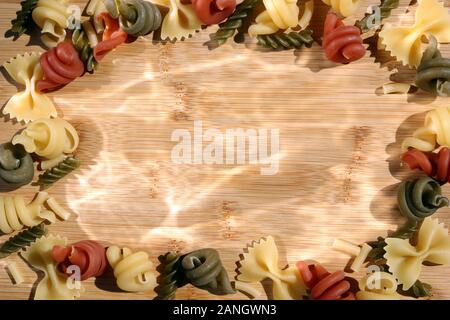 Multicolored Pasta Frame on a Wooden Background Stock Photo