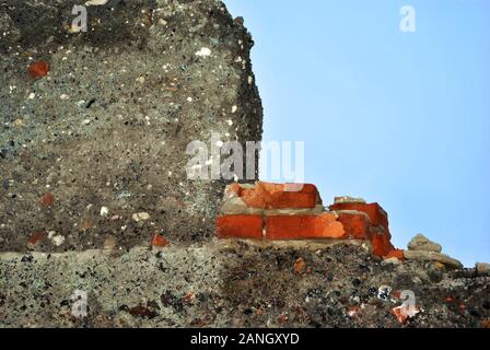 Gray old cement on the bricks wall, grunge texture on blue sky background Stock Photo