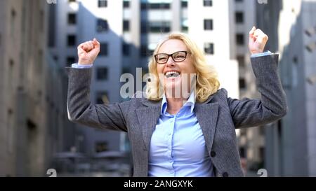Elderly business lady suit dancing, feeling happy of work success, inspiration Stock Photo