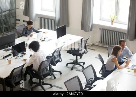 Top view of diverse people working at computers online in shared office collaborating, company managers or workers busy using pc, preparing financial Stock Photo