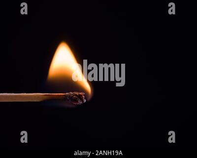 burning match on black background Stock Photo