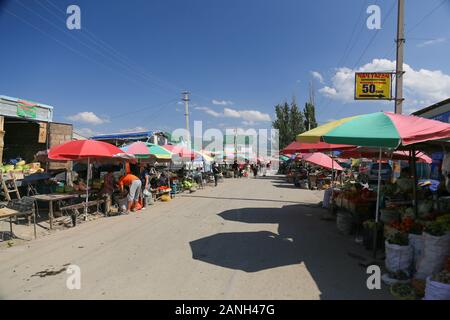 A regular street in town center Karakol - one of the bigest and busiest streets of Kyrgyzstan - Karakol Stock Photo