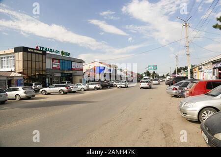 A regular street in town center Karakol - one of the bigest and busiest streets of Kyrgyzstan - Karakol Stock Photo