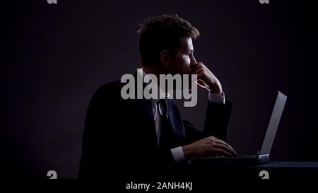 Pensive male in suit thinking about new start-up project, looking for ideas Stock Photo