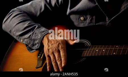 Man playing acoustic guitar, music school lessons, art and creativity concept Stock Photo