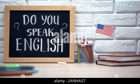 Do you speak English written on board, international flag in box, language Stock Photo