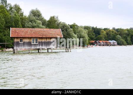 Wooden cottage on pier on the lake Ammersee in Inning am Ammersee, Germany Stock Photo