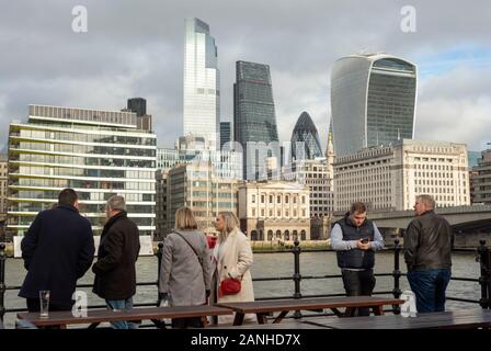 The City of London as seen from Pickfords Wharf and tourists in the South Bank, London, UK, Europe as of 2020 Stock Photo