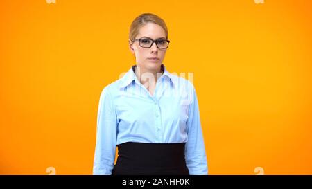 Strict female boss looking at company employee, irritated head of ...