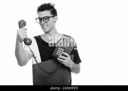 Angry young man holding old telephone in black and white Stock Photo