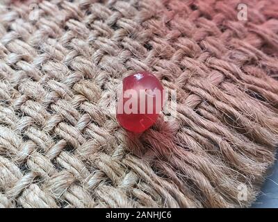On a burlap are pomegranate seeds close-up. Macro shot. Healthy eating Vitamin juice. Copy space. Stock Photo