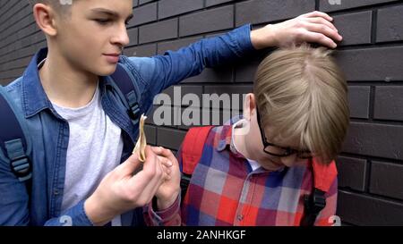 Teenage boy bullying classmate and stealing his money Stock Photo - Alamy