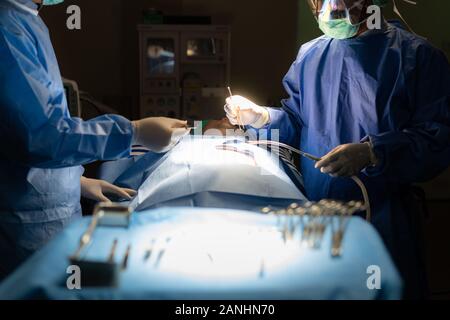 Doctor surgery team in the operating room of abdominal cesarean section during child birth at patient nurse emergency hospital. Stock Photo
