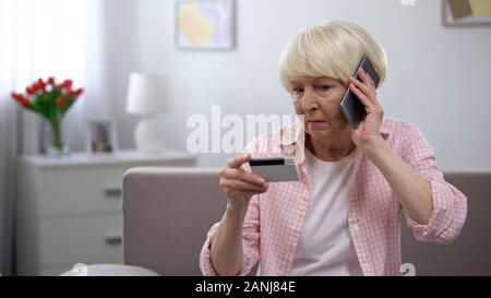 Aged woman calling children asking for help with using banking card, generation Stock Photo