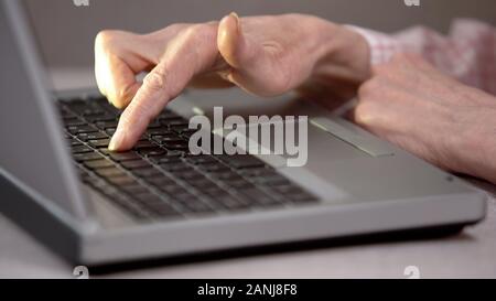 Aged woman texting message on laptop, studying modern technologies, generation Stock Photo