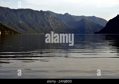 The morning light is reflected on the calm waters of the small lake Stock Photo