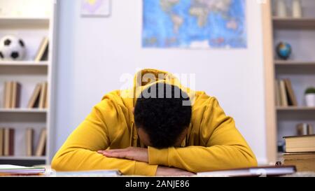 Overworked african-american student napping preparing for test, lack of energy Stock Photo