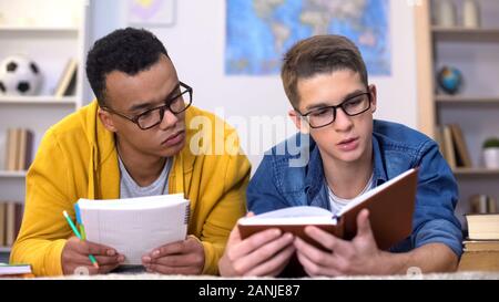 Two multiracial students preparing collective assignment, college education Stock Photo