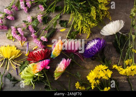 Variety of colorful spring flowers on wooden table. Top view Stock Photo