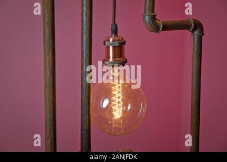 Beautiful retro luxury light lamp decor glowing. classic different retro light bulbs hanging on brick red background at night . Decorative antique edi Stock Photo
