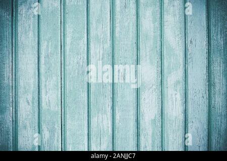 Light colored timber fence with peeling paint. Shabby decrepit wooden boards. Wood lamellas. Blue rough painted planks surface. Abstract wallpaper. Vi Stock Photo