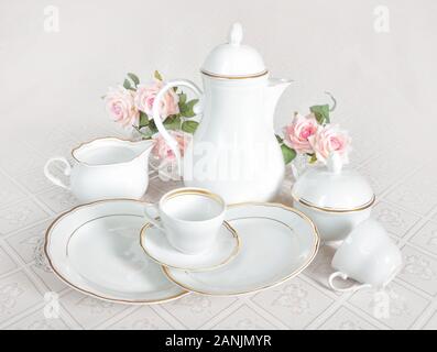 https://l450v.alamy.com/450v/2anjmyr/classic-white-crockery-for-tea-ore-coffee-teapot-coffee-pot-cup-serving-plate-sugar-bowl-and-creamer-on-a-beautiful-tablecloths-2anjmyr.jpg