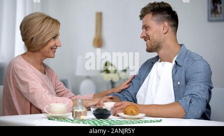 Mother admiring adult son, long-awaited meeting, spending time together concept Stock Photo