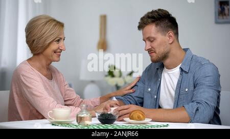 Happy mother and son talking as having tea time, long-awaited meeting, care Stock Photo
