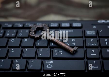 Close up old key and push-button the computer keyboard, Data protection by key concept Stock Photo