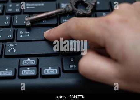 Close up female Index finger push button Enter on the computer keyboard, Data protection by key concept Stock Photo