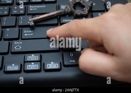 Close up female Index finger push button Enter on the computer keyboard, Data protection by key concept Stock Photo