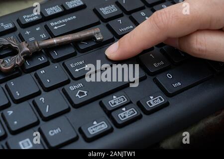 Close up female Index finger push button Enter on the computer keyboard, Data protection by key concept Stock Photo