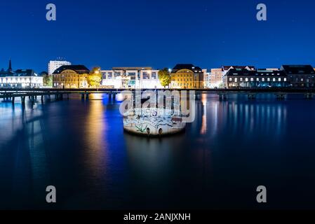 Old big boat that ran aground, an old boat lies on the ground, night shot, colorful, Berlin, Treptow harbor Stock Photo