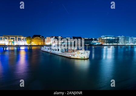 Old big boat that ran aground, an old boat lies on the ground, night shot, colorful, Berlin, Treptow harbor Stock Photo