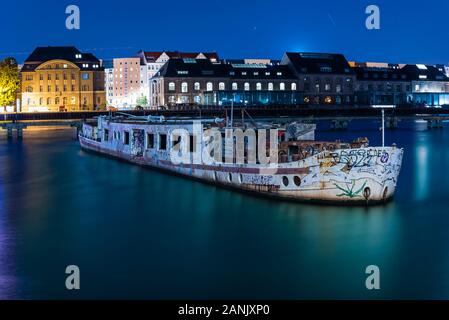 Old big boat that ran aground, an old boat lies on the ground, night shot, colorful, Berlin, Treptow harbor Stock Photo