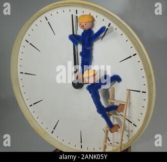 Clockmen adjusting a clock to or back from Daylight Saving Time (DST) Stock Photo