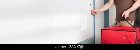 Close-up Of A Young Pizza Delivery Man Ringing The Door Bell Stock Photo