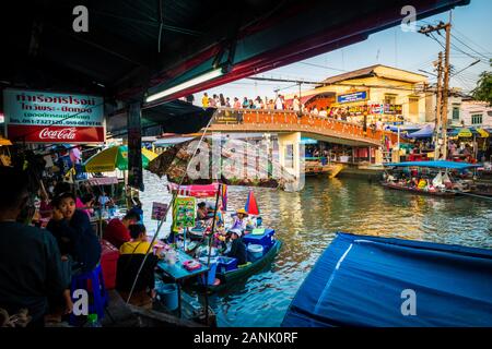 Amphawa/Thailand-13December2019: Classical view down on the daily floating market with the blue roof covered boats on the canal and tourists passing Stock Photo