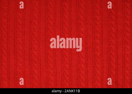 Real red knitted fabric with cable pattern textured background Stock Photo