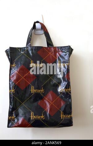 A Harrods shopping bag being carried by a shopper Stock Photo - Alamy