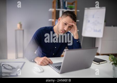 Stressful Business Man Working On Laptop In Office Stock Photo