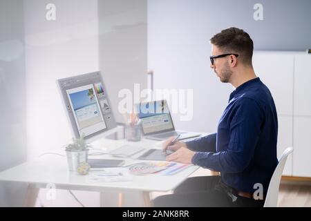 Close-up Of A Designer's Hand Editing Photo On Computer In Office Stock Photo