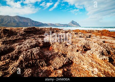 The unique shape of the volcanic beach in sunlight. Picturesque day and gorgeous scene. Famous tourist attraction. Location place cape San Vito, Monte Stock Photo