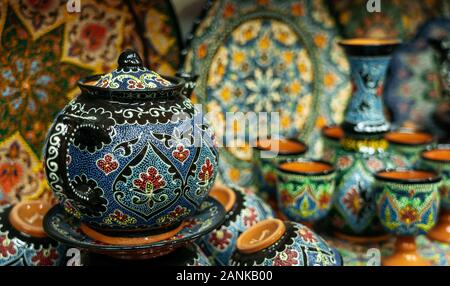 Ethnic Uzbek ceramic tableware. Decorative ceramic plates and cups with traditional uzbekistan ornament. Stock Photo
